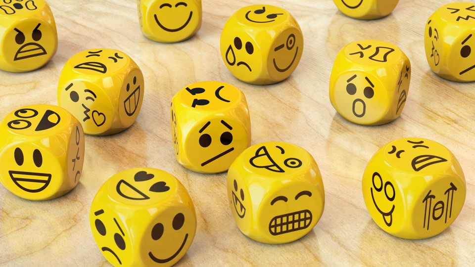 Yellow dice with different facial expressions